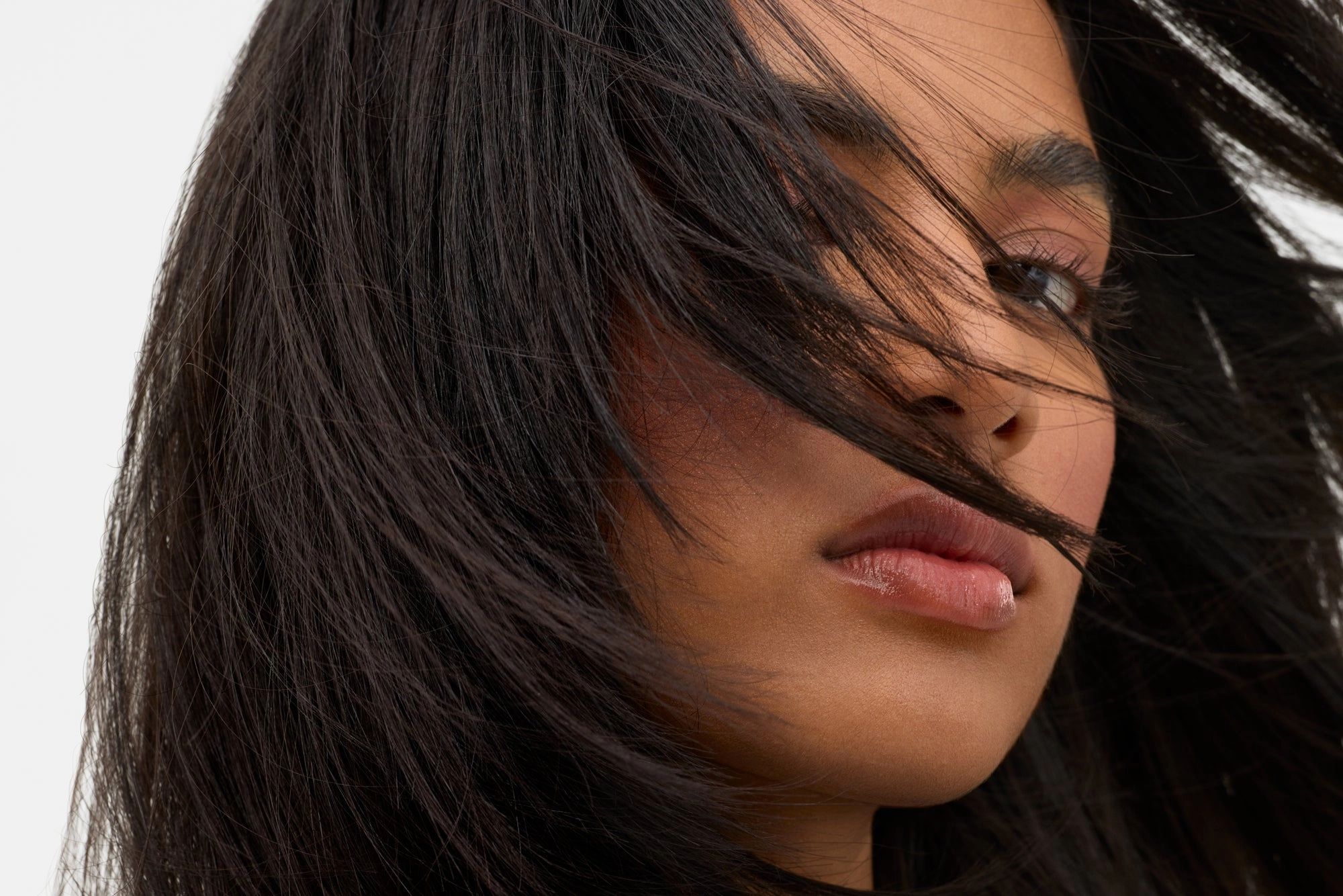 Woman with voluminous dark hair across her face