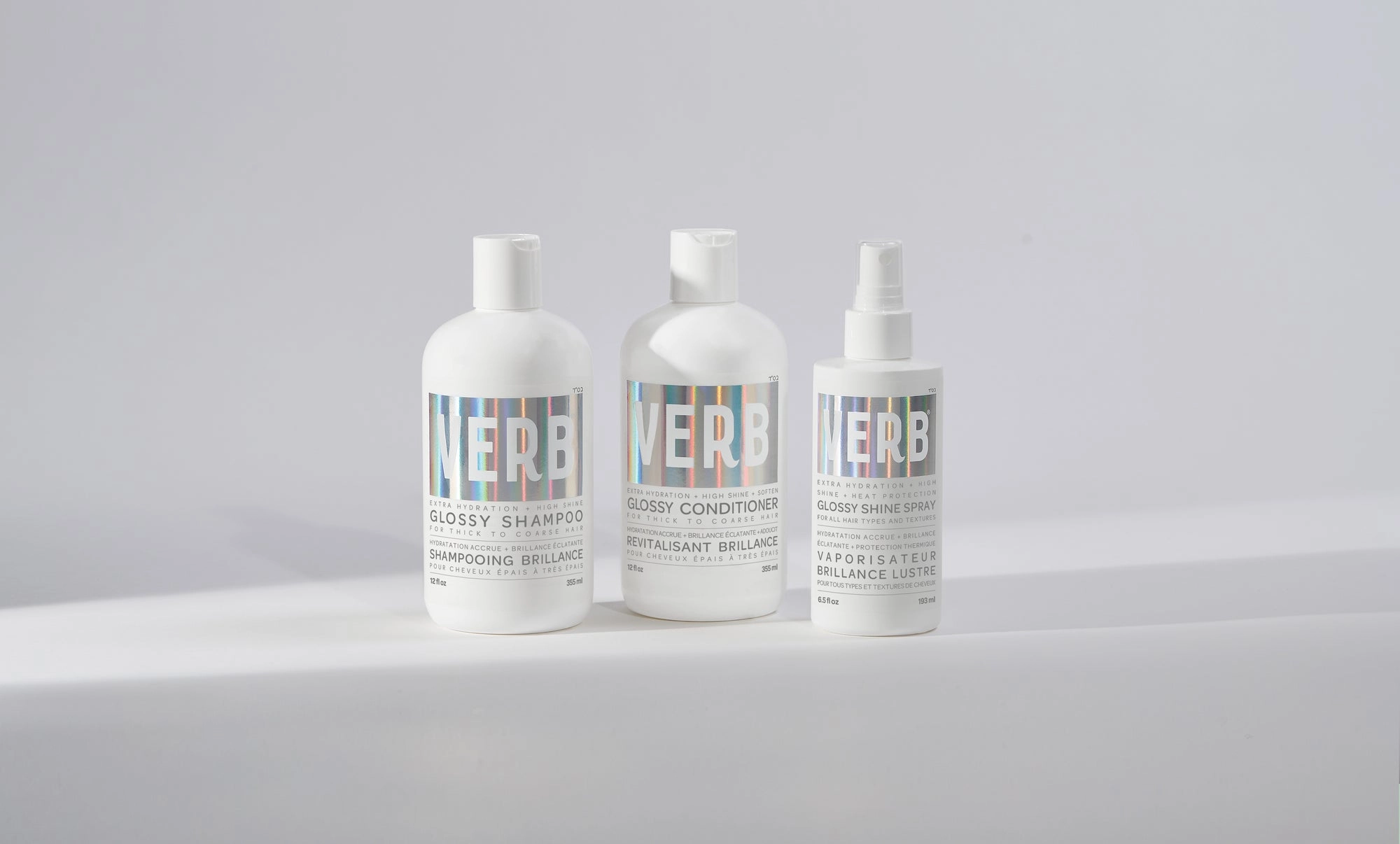 Glossy shampoo and conditioner in white bottles